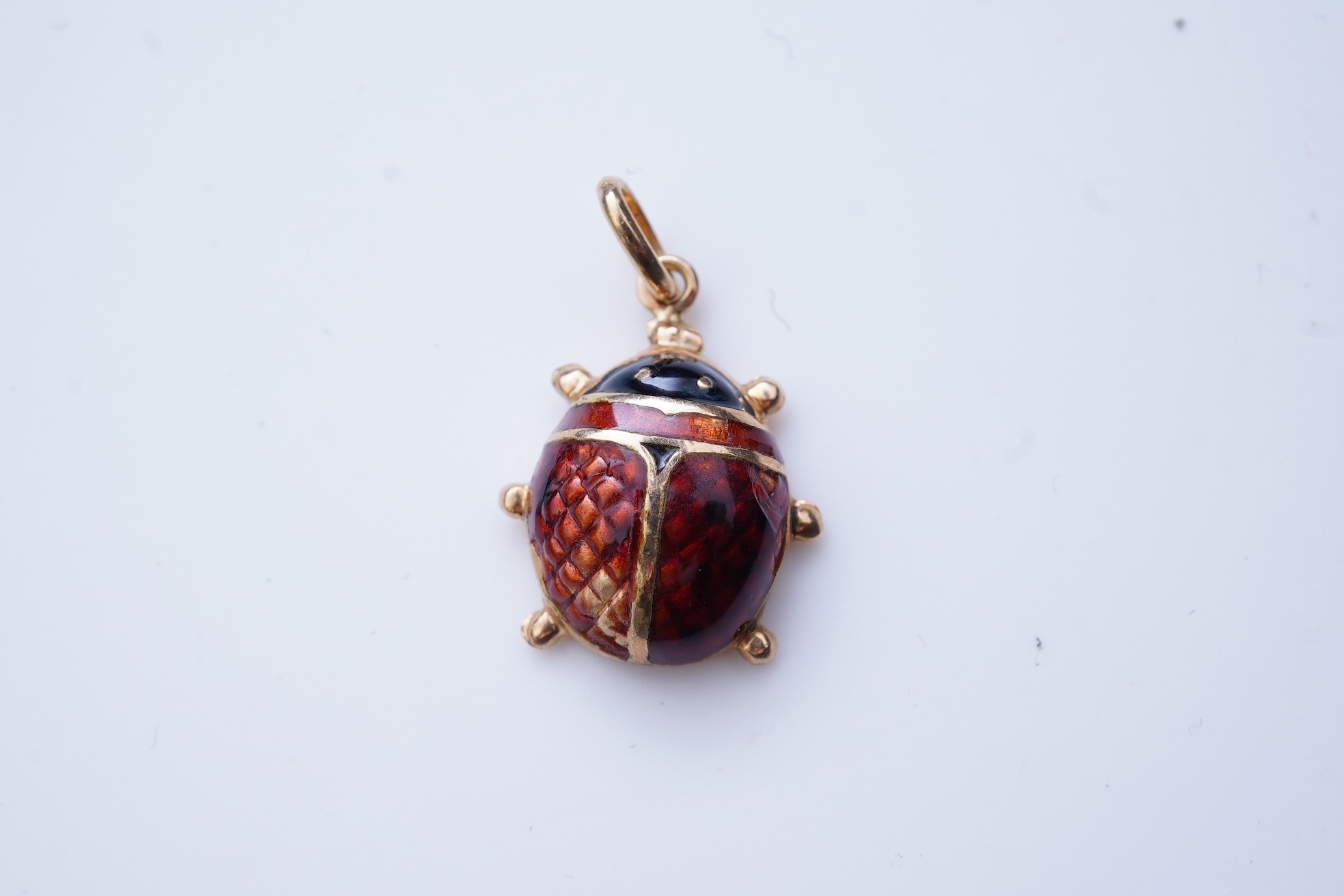 A gold and enamel pendant, Italy, 1960s